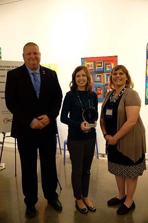 Rob Hill and Rachel Riley receive the award from APA Oklahoma President Danielle Barker.