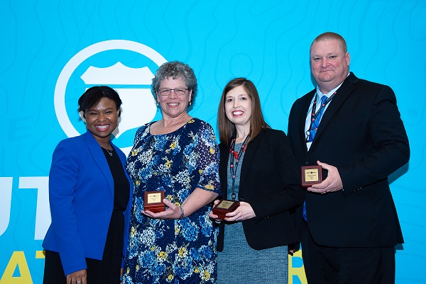 Rachel Riley, Paula Dennison and Rob Hill receiving the award from Alisha Powell Gillis, Route Fifty Senior Editor.